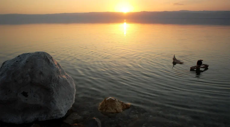 Floating on the Dead Sea at sunset